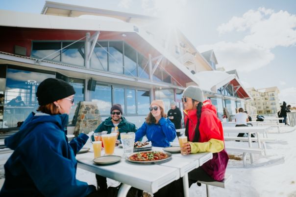 visitors enjoying Mt Hotham at a picnic table