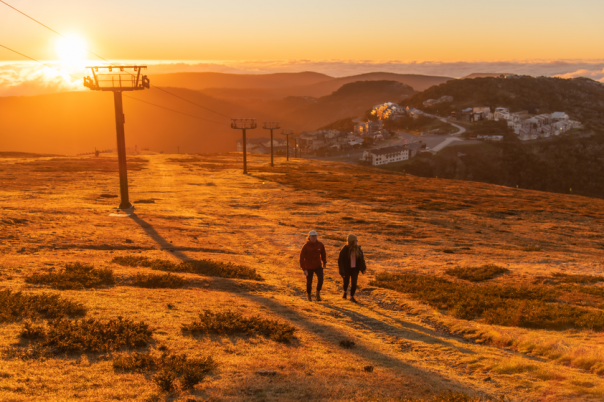 Two walkers on Mt Hotham at sunrise