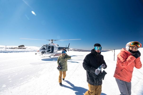 group of people existing a helicopter