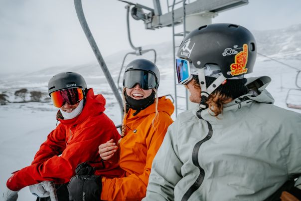Happy people enjoying resorts on ski lift