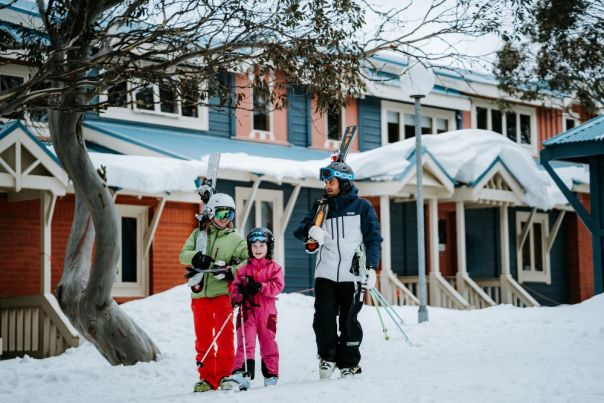 Mt Hotham skiers family in front of property in snow
